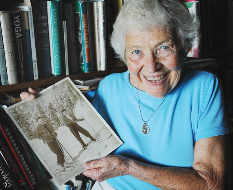 Iola holds a picture of herself and a friend skiing in 1946