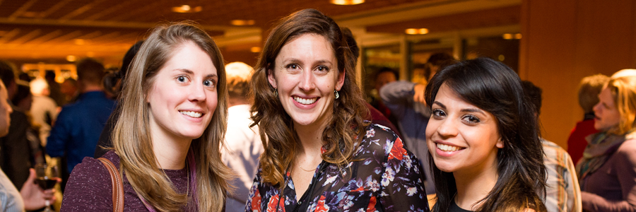 three women smiling at the camera