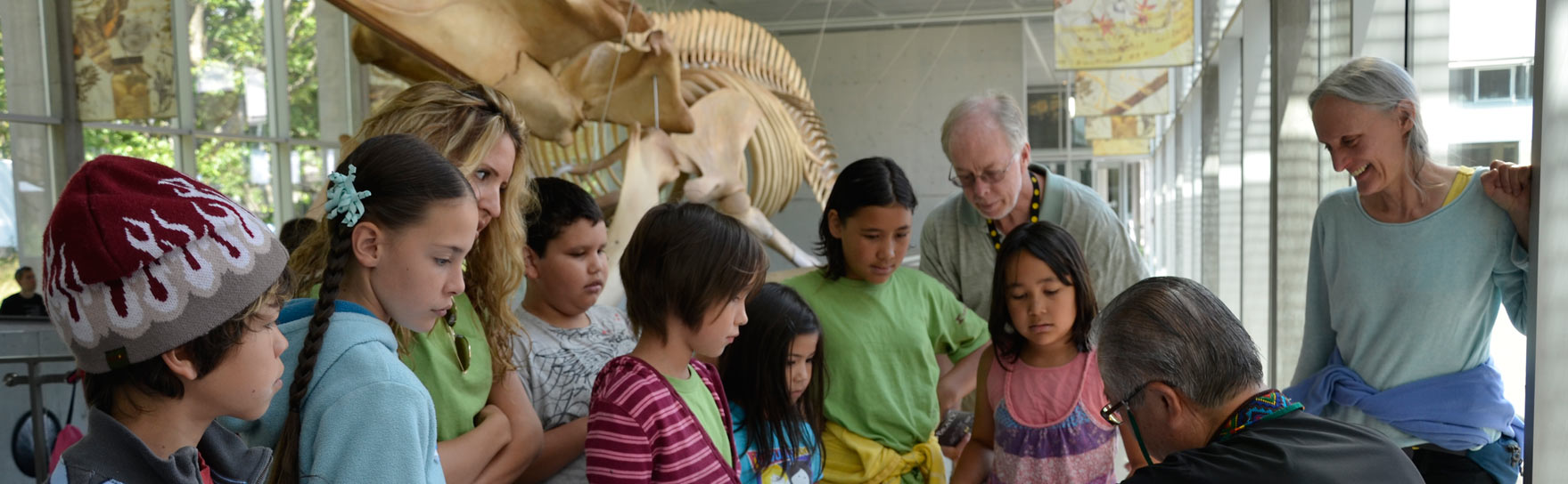 A group of young students standing inside the Beaty Museum