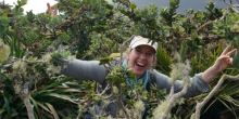 Photo of Claire Floriet standing amongst plants