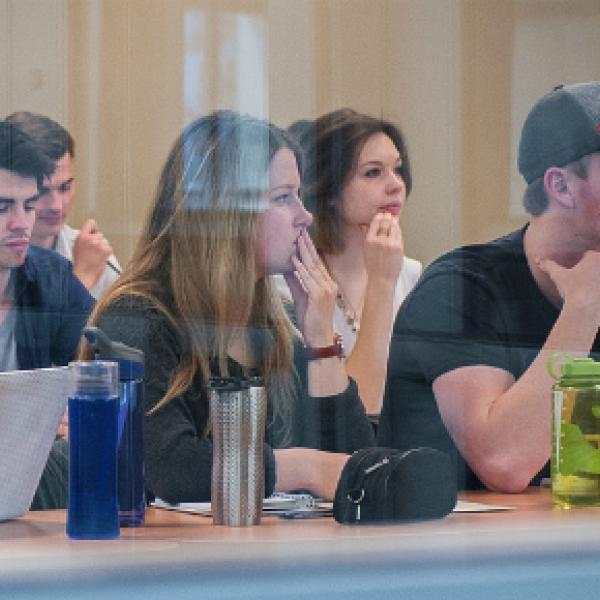 Students sitting in a row with their laptops.