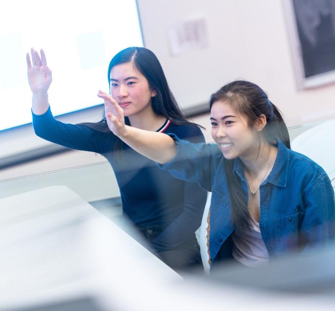students raising their hands